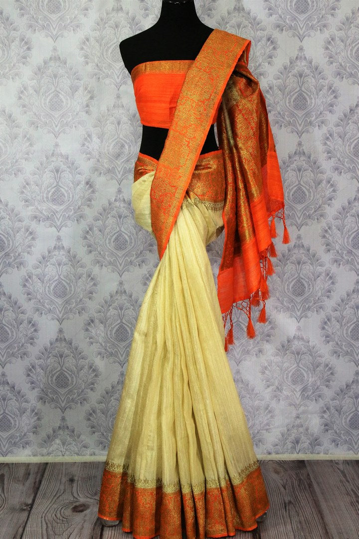 Buy cream Benarasi tussar saree online in USA with orange border. Browse through a range of traditional Indian sarees in USA at Pure Elegance online store. Shop now.-full view