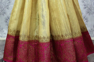 Buy cream Benarasi tussar saree online in USA with pink border. Browse through a range of traditional Indian sarees for weddings at Pure Elegance online store.-pleats