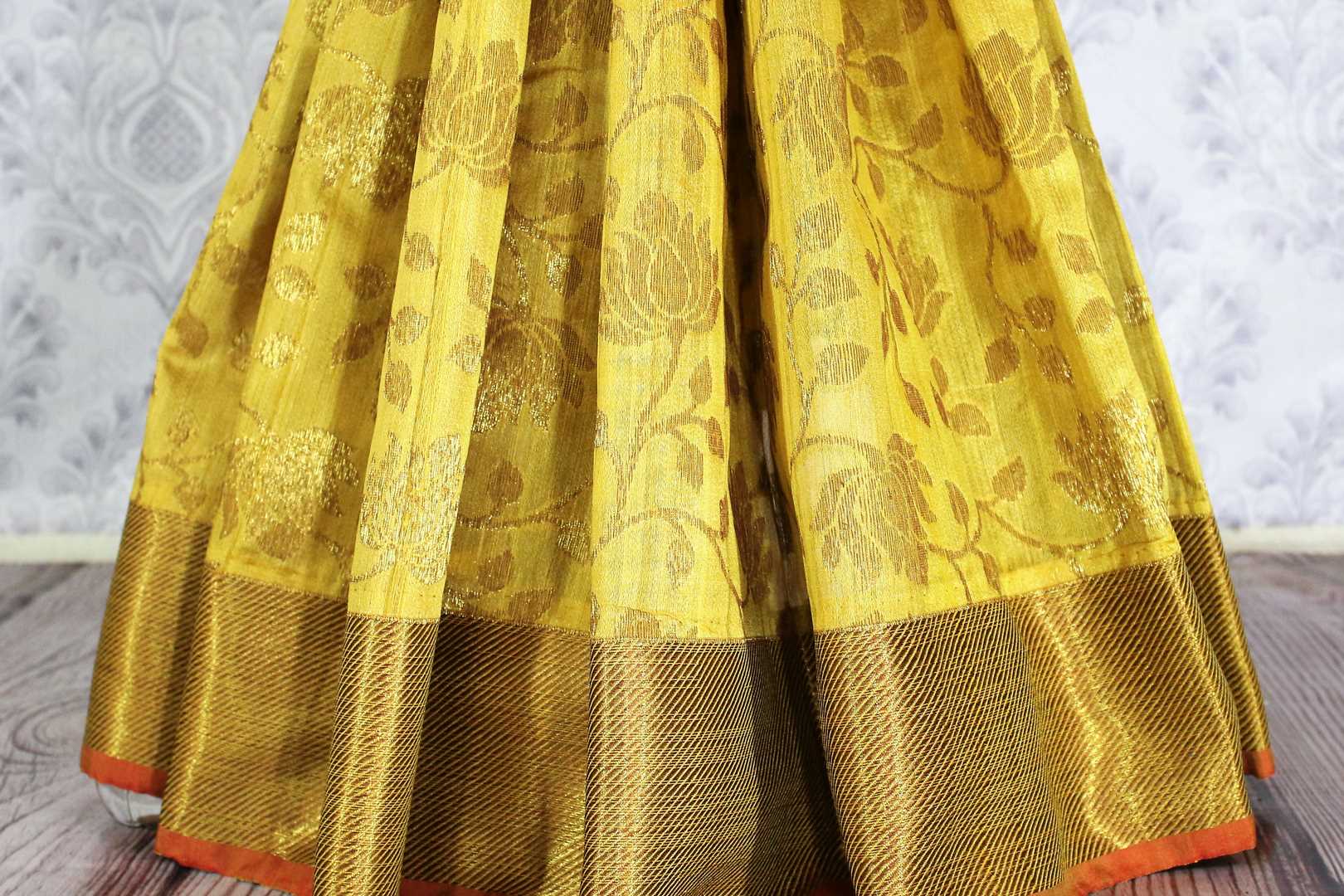 Yellow Muga Benarasi sari with golden border buy online in USA. Explore a range of exclusive Banarasi sarees in USA at Pure Elegance Indian clothing store.-pleats