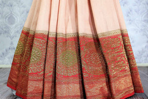 Peach Muga Banarasi saree with red border buy online in USA. Explore a range of exclusive Banarasi sarees in USA at Pure Elegance Indian clothing store for women.-pleats