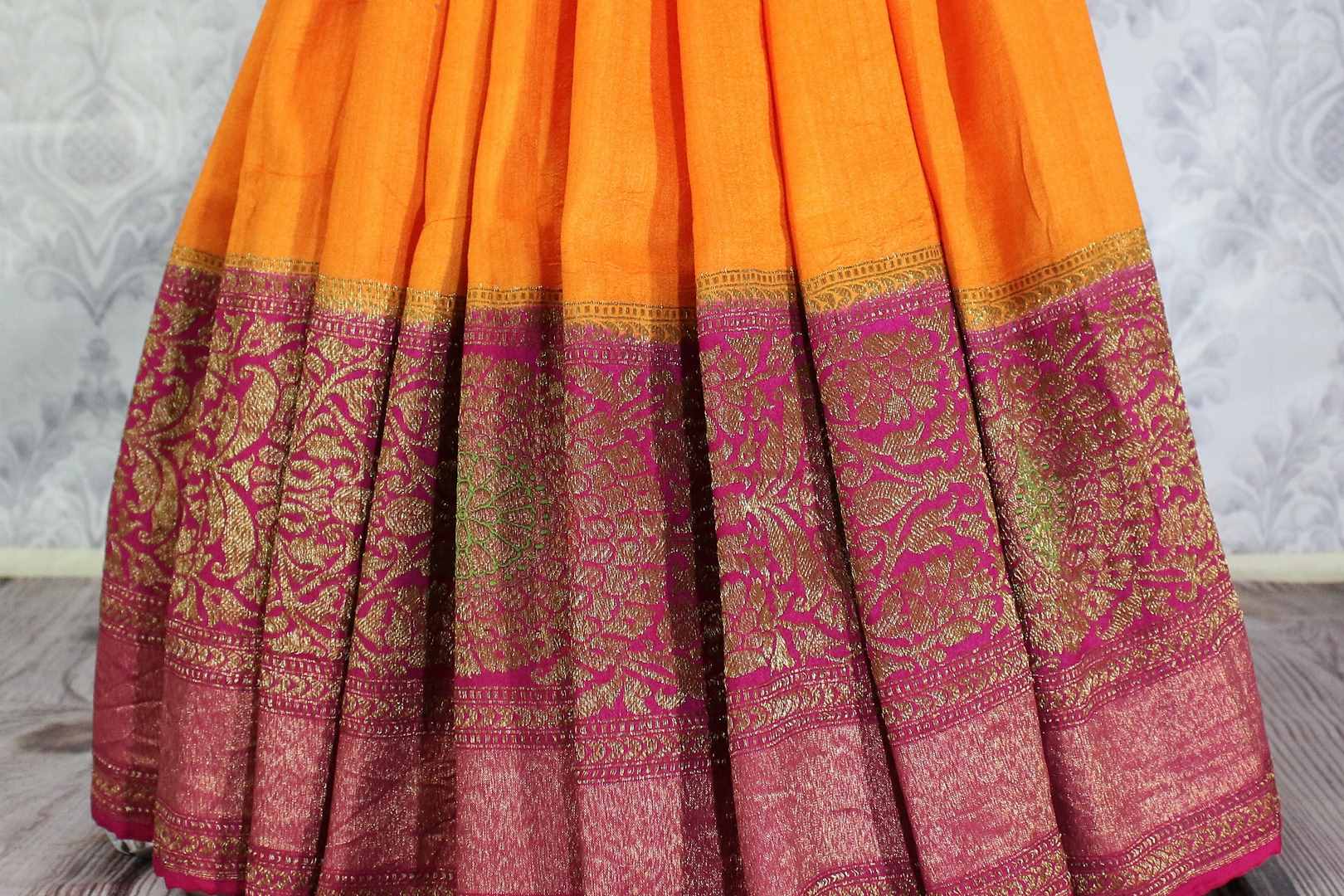 Bright yellow Muga Banarasi saree with antique zari border buy online in USA. Explore a range of Indian wedding sarees in USA at Pure Elegance clothing store for women.-pleats