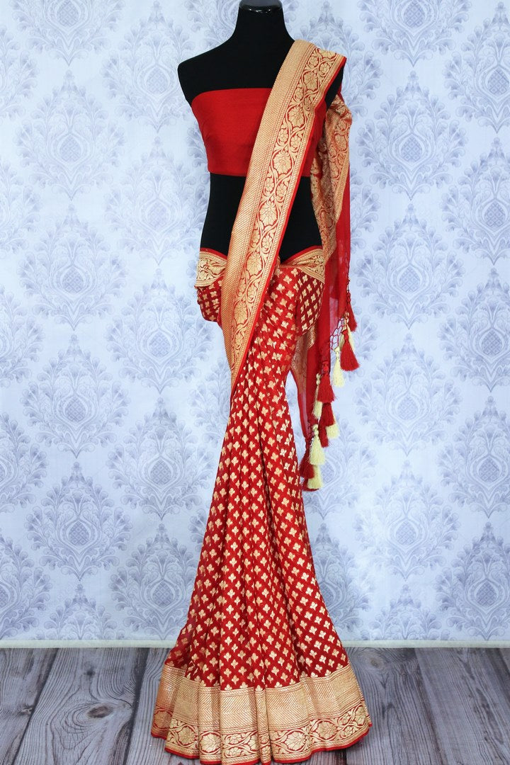 Buy bright red georgette Banarasi saree online in USA. The alluring design of the saree with overall zari work and buta makes it perfect for a traditional wedding look. Select from an exquisite collection of traditional Indian Banarasi sarees, designer saris at Pure Elegance clothing store or shop online.-full view