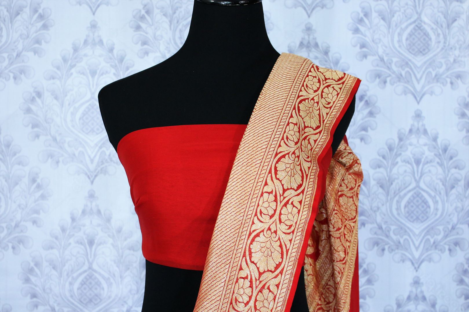Buy bright red georgette Banarasi saree online in USA. The alluring design of the saree with overall zari work and buta makes it perfect for a traditional wedding look. Select from an exquisite collection of traditional Indian Banarasi sarees, designer saris at Pure Elegance clothing store or shop online.-blouse pallu