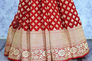 Buy bright red georgette Banarasi saree online in USA. The alluring design of the saree with overall zari work and buta makes it perfect for a traditional wedding look. Select from an exquisite collection of traditional Indian Banarasi sarees, designer saris at Pure Elegance clothing store or shop online.-pleats
