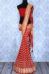 Buy ethnic red georgette Banarasi saree online in USA. The alluring design of the saree with overall zari work and buta makes it perfect for weddings. Select from an exquisite collection of traditional Indian Banarasi sarees, designer saris at Pure Elegance clothing store or shop online.-full view