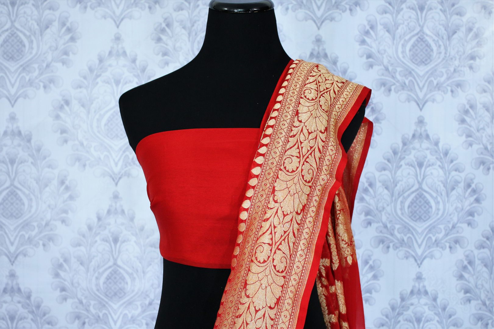 Buy ethnic red georgette Banarasi saree online in USA. The alluring design of the saree with overall zari work and buta makes it perfect for weddings. Select from an exquisite collection of traditional Indian Banarasi sarees, designer saris at Pure Elegance clothing store or shop online.-blouse pallu
