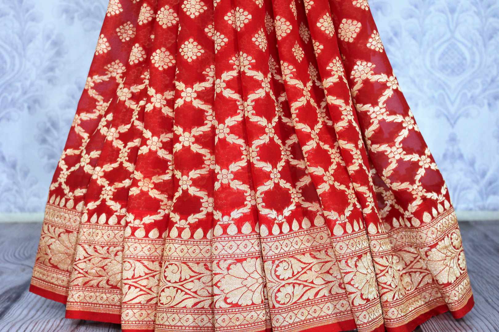 Buy ethnic red georgette Banarasi saree online in USA. The alluring design of the saree with overall zari work and buta makes it perfect for weddings. Select from an exquisite collection of traditional Indian Banarasi sarees, designer saris at Pure Elegance clothing store or shop online.-pleats