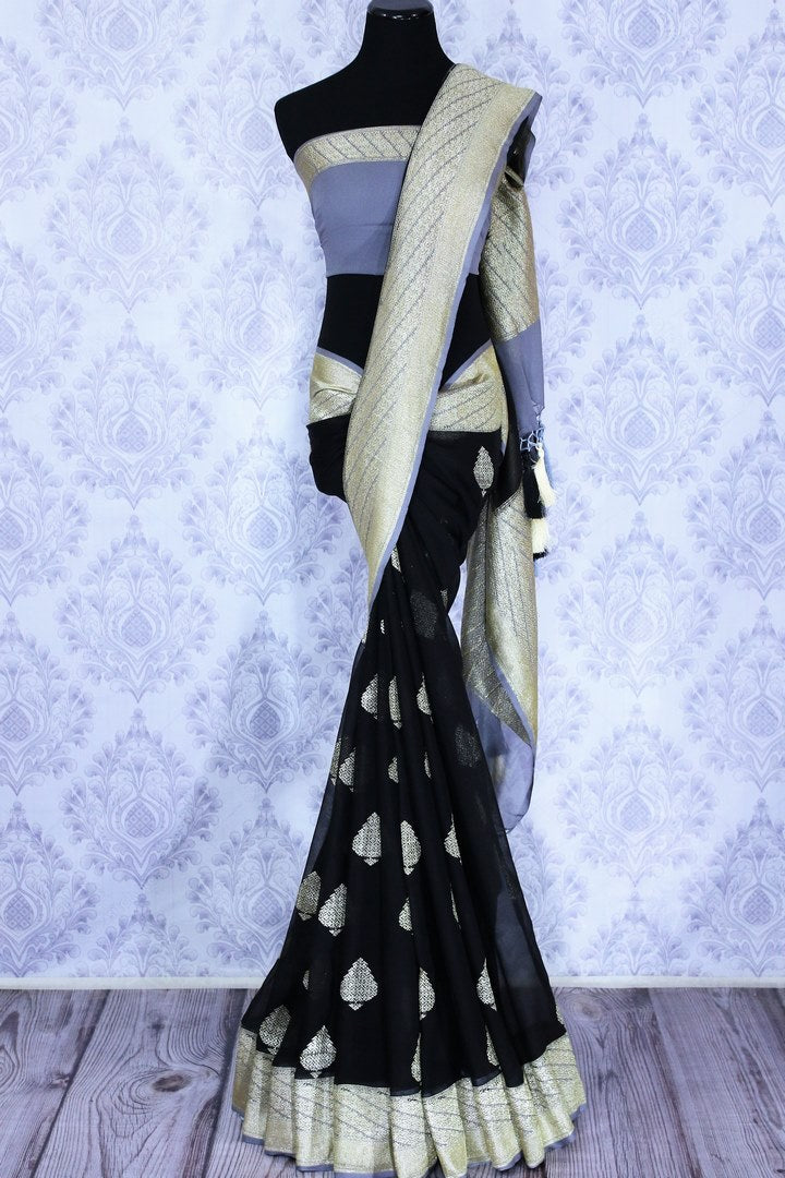 Black georgette Banarasi saree with silver buta for online shopping in USA. The traditional saree is contrasted with a light blue zari border which makes it so captivating. Select from an exquisite collection of traditional Indian Banarasi sarees, designer sarees at Pure Elegance clothing store or shop online.-full view
