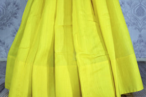 Buy lemon yellow muga Banarasi sari online in USA. The bright saree is a great choice for a classic Indian saree look at special occasions. Select from an exquisite collection of traditional Indian Banarasi sarees, silk sarees at Pure Elegance clothing store or shop online for weddings, parties, and festivals.-pleats