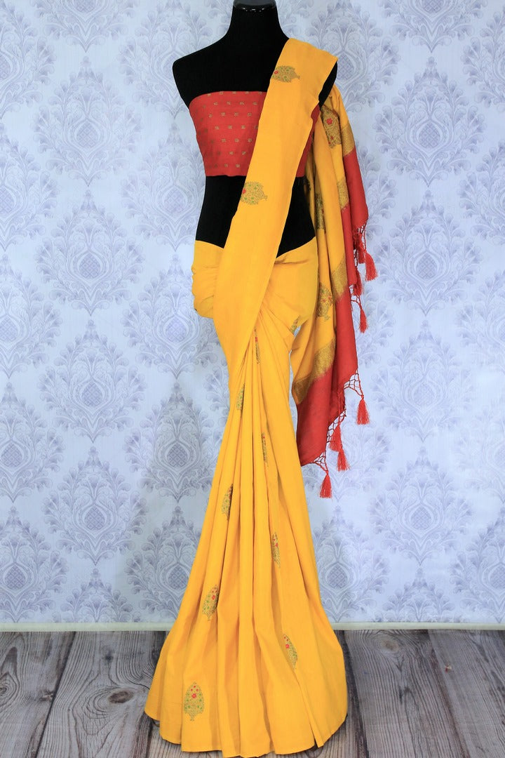 This yellow muga banarsi silk saree is totally stealing our heart away. The vibrant hued embroidered silk sari is perfect for festivities and weddings. Style this gorgeous sari with contrasting bright red designer blouse. Shop designer silk sarees, printed sarees, ikkat sari online or visit Pure Elegance store in USA.-full view