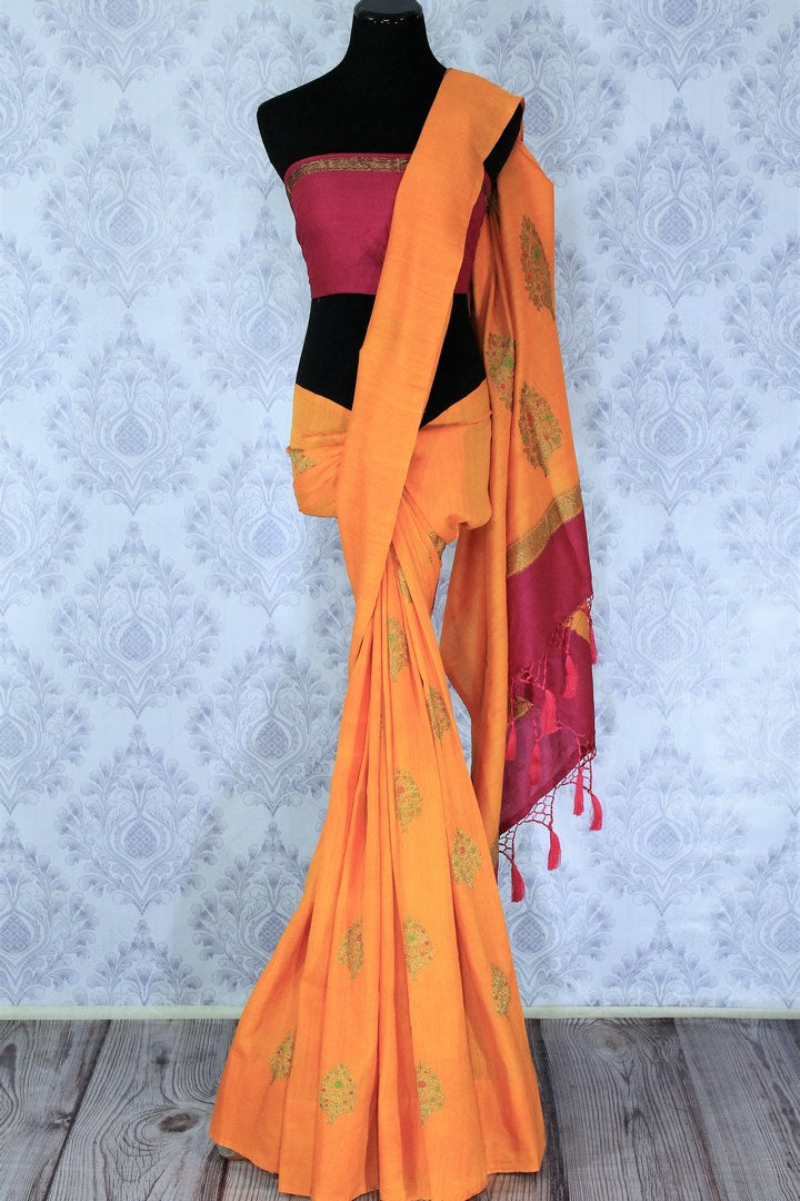 Escalate your style game with this exquisitely designed orange embroidered muga banarsi silk sari. Pair this stunning saree with pink raw silk and embroidered blouse complemented with purple border and embroidery. Shop designer silk sarees, printed saris, banarsi saris online or visit Pure Elegance store in USA. -full view