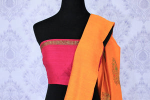 Escalate your style game with this exquisitely designed orange embroidered muga banarsi silk sari. Pair this stunning saree with pink raw silk and embroidered blouse complemented with purple border and embroidery. Shop designer silk sarees, printed saris, banarsi saris online or visit Pure Elegance store in USA. -blouse pallu