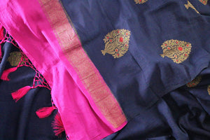 Dress up for weddings and special events in this royal blue designer muga banarsi silk sari with a stunning zari work. Style this glorious saree with a contrasting pink blouse complemented with a pink border on the heavily embroidered pallu to turn heads. Shop designer sarees online or visit Pure Elegance store in USA.-details