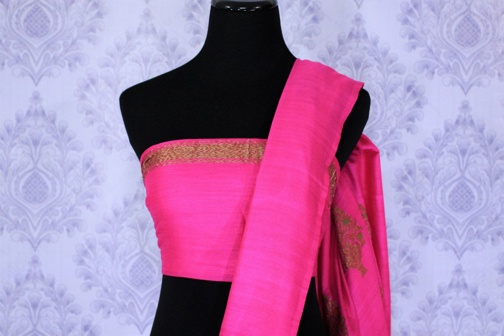 Be the showstopper in this exquisitely designed bright pink embroidered muga banarsi silk sari with zari detailing. Style this vibrant sari with a magenta blouse and  the heavily embroidered pallu for weddings or parties. Shop printed silk sarees, crepe silk saris, ikkat sarees online or visit Pure Elegance store in USA. -blouse pallu
