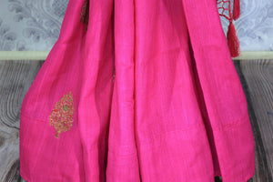 Be the showstopper in this exquisitely designed bright pink embroidered muga banarsi silk sari with zari detailing. Style this vibrant sari with a magenta blouse and  the heavily embroidered pallu for weddings or parties. Shop printed silk sarees, crepe silk saris, ikkat sarees online or visit Pure Elegance store in USA. -pleats