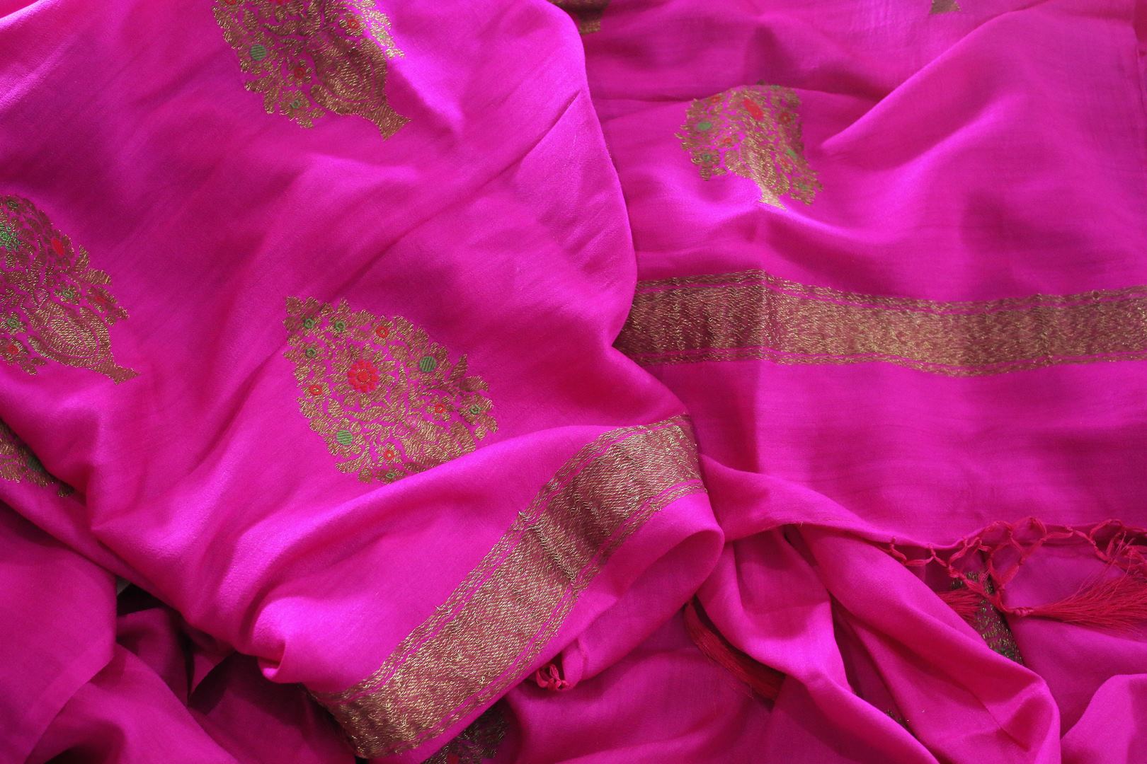 Be the showstopper in this exquisitely designed bright pink embroidered muga banarsi silk sari with zari detailing. Style this vibrant sari with a magenta blouse and  the heavily embroidered pallu for weddings or parties. Shop printed silk sarees, crepe silk saris, ikkat sarees online or visit Pure Elegance store in USA. -details