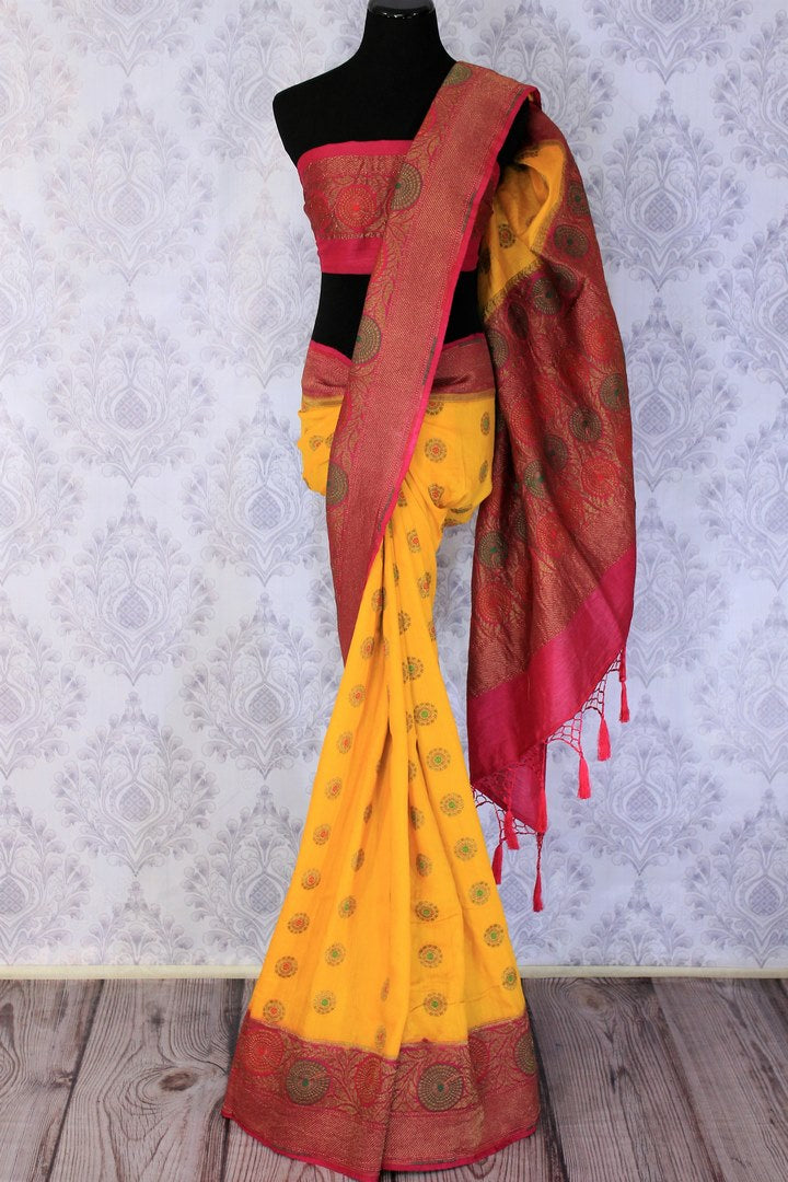 Your perfect wedding ensemble in traditional yellow and red combination with zari detailing is oh so dreamy. Indulge in this breath-taking muga banarsi silk saree complemented with a heavy woven red pallu and designer red blouse. Shop designer silk sarees, ikkat sarees online or visit Pure Elegance store in USA.-full view