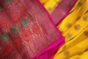 Your perfect wedding ensemble in traditional yellow and red combination with zari detailing is oh so dreamy. Indulge in this breath-taking muga banarsi silk saree complemented with a heavy woven red pallu and designer red blouse. Shop designer silk sarees, ikkat sarees online or visit Pure Elegance store in USA.-details