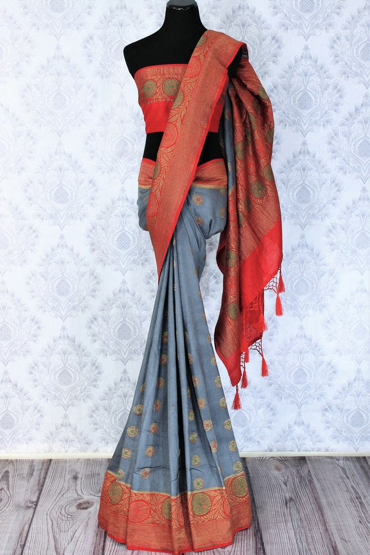 Relish the exquisite wedding ensemble with this grey and red combination of muga banarsi silk saree. The zari border complemented with a stunning red embroidered designer blouse and a heavily woven red zari pallu is such an eye-catcher. Shop designer silk saris,printed sarees online or visit Pure Elegance store in USA.-full view
