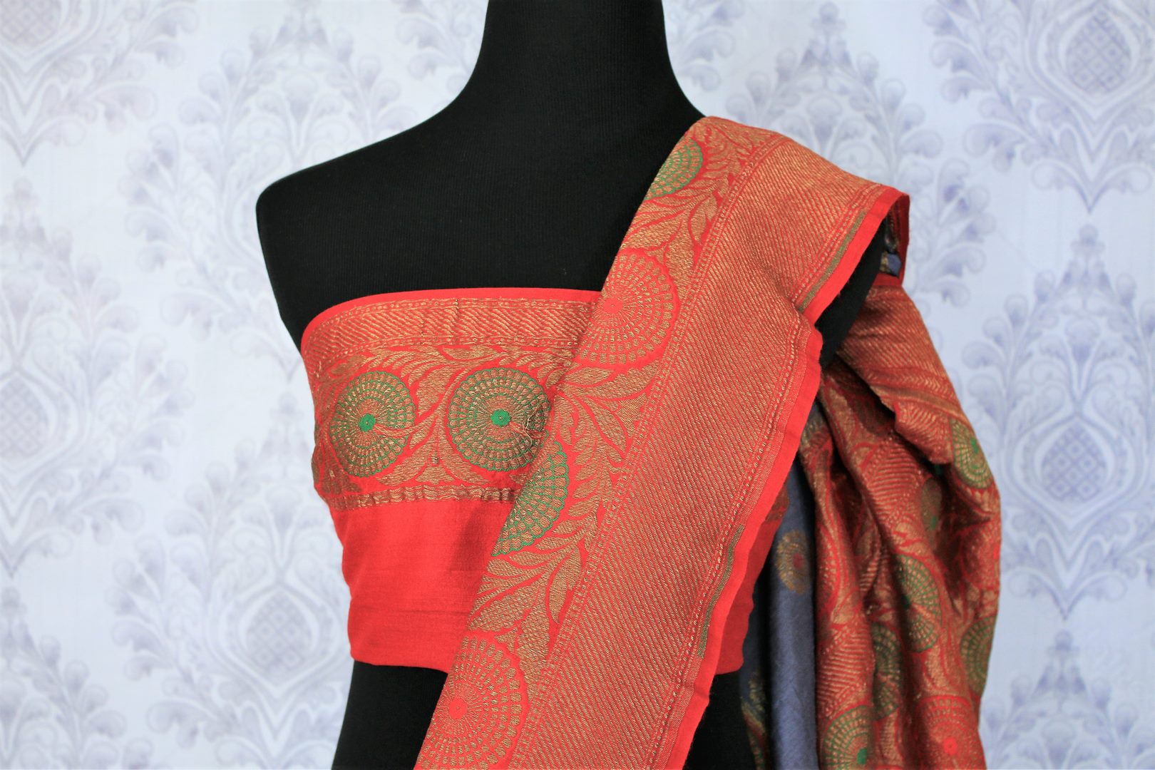 Relish the exquisite wedding ensemble with this grey and red combination of muga banarsi silk saree. The zari border complemented with a stunning red embroidered designer blouse and a heavily woven red zari pallu is such an eye-catcher. Shop designer silk saris,printed sarees online or visit Pure Elegance store in USA.-blouse pallu