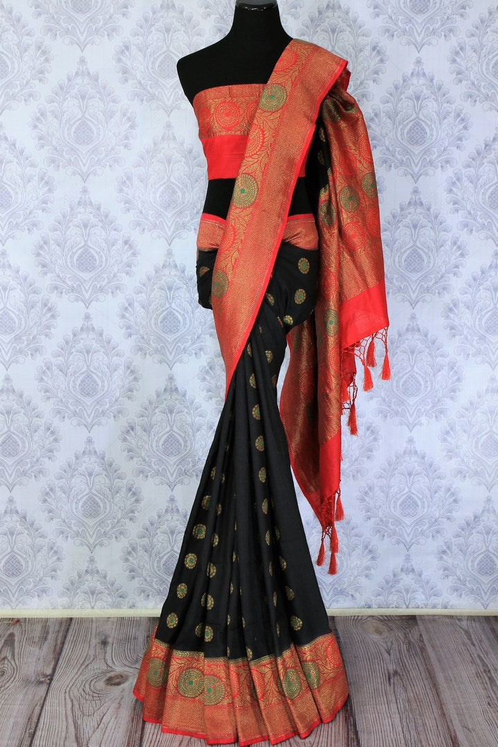 This black buta work muga banarsi silk sari complemented with a stunning red zari border and a heavily embroidered woven red pallu adds a touch of grace. Style it with a red designer blouse to strut at weddings or parties. Shop designer silk sarees, printed saris online or visit Pure Elegance store, USA. -full view