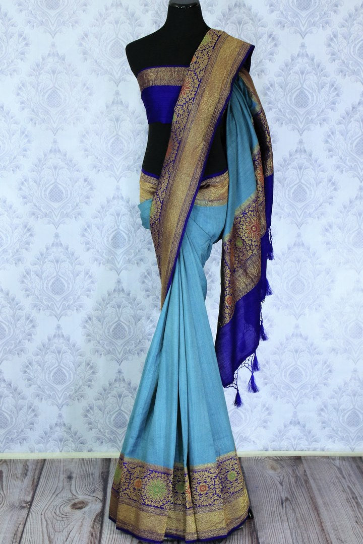 Dress up like a chic in this blue half-half designer muga banarsi silk saree. Complemented with a royal blue zari embroidered blouse and a heavily woven pallu, you will look no less than an Indian traditional lady. Shop designer sarees, printed saress, ikkat saris online or visit Pure Elegance store, USA.-full view