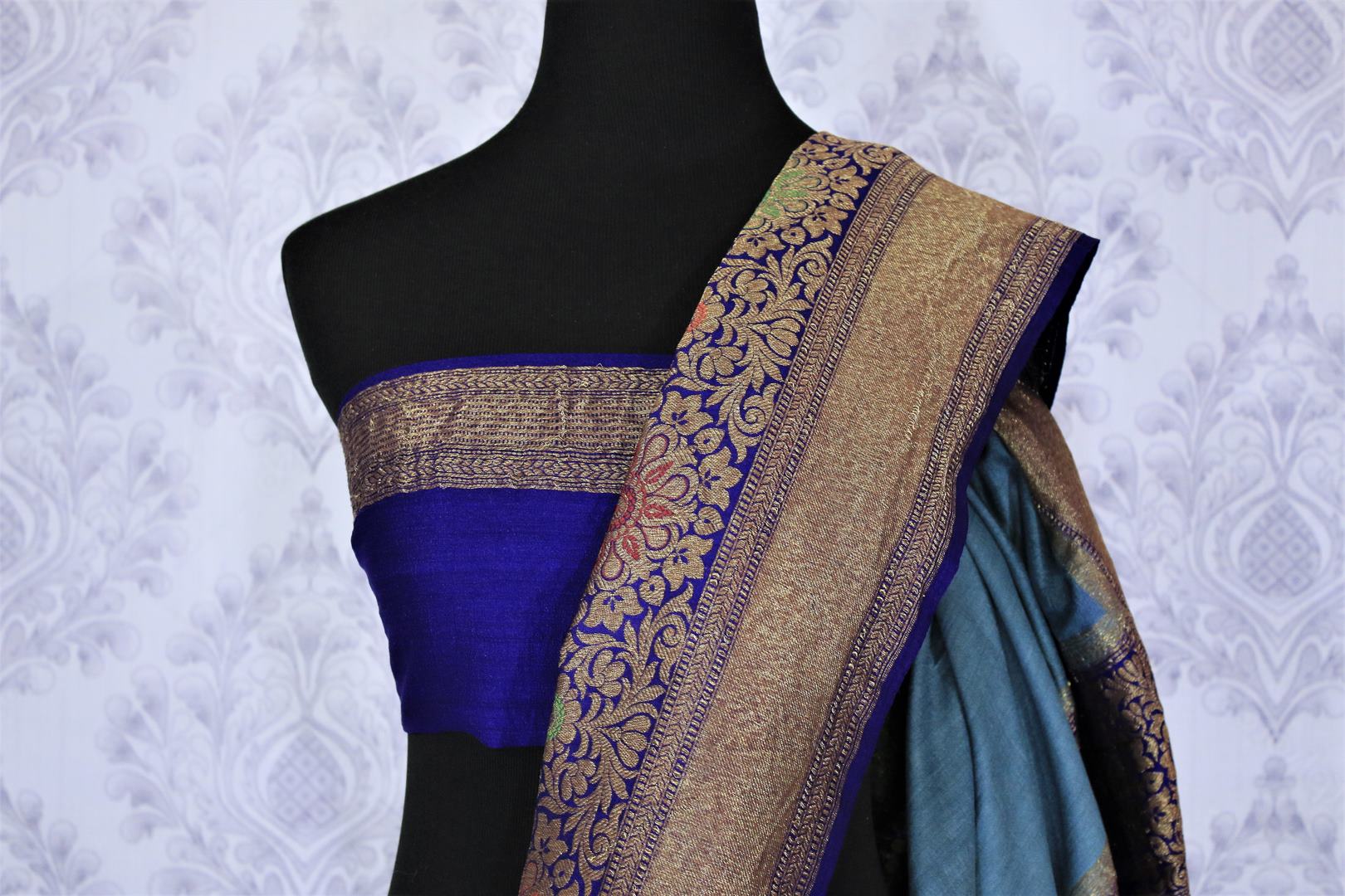 Dress up like a chic in this blue half-half designer muga banarsi silk saree. Complemented with a royal blue zari embroidered blouse and a heavily woven pallu, you will look no less than an Indian traditional lady. Shop designer sarees, printed saress, ikkat saris online or visit Pure Elegance store, USA.-blouse pallu
