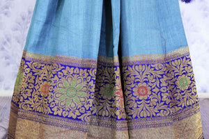 Dress up like a chic in this blue half-half designer muga banarsi silk saree. Complemented with a royal blue zari embroidered blouse and a heavily woven pallu, you will look no less than an Indian traditional lady. Shop designer sarees, printed saress, ikkat saris online or visit Pure Elegance store, USA.-pleats