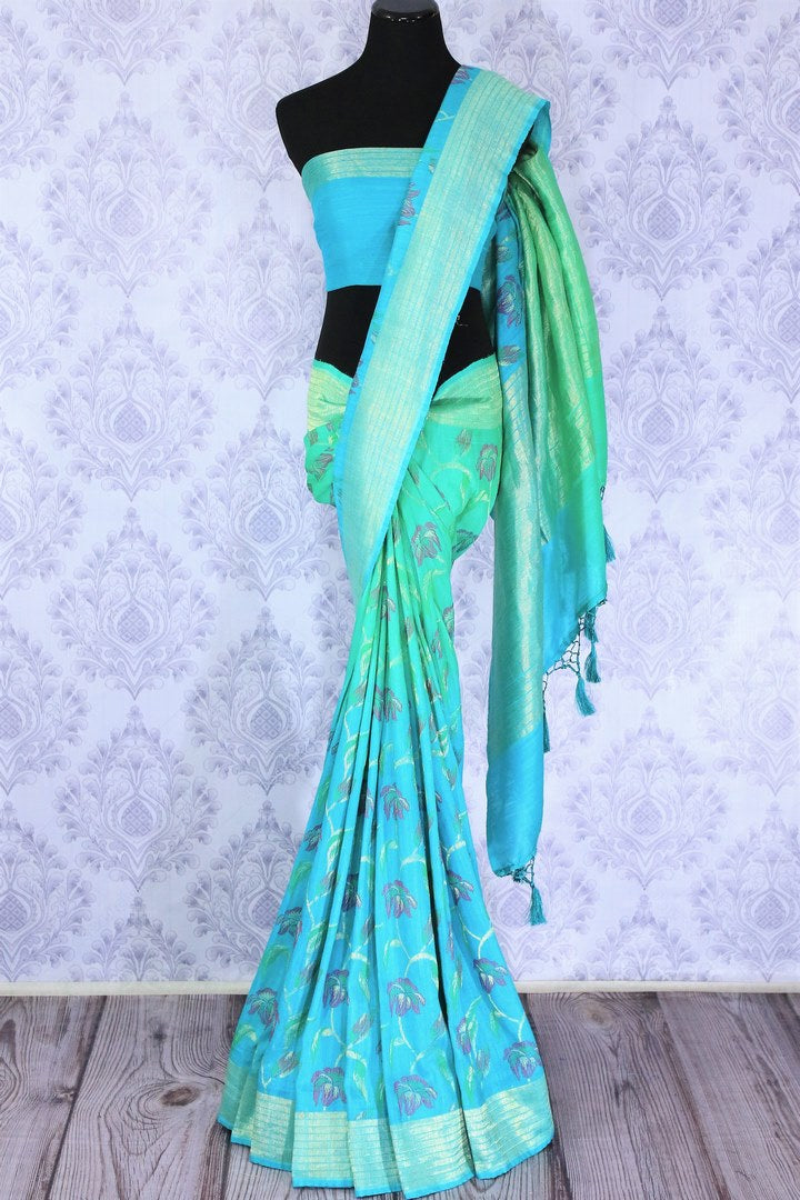 Emanate suave vibes as you drape this green floral embroidered muga banarsi silk saree. It comes with a stunning zari pallu and turquoise shaded blouse. The striking blend of colors is flawless. Shop designer silk sarees, ikkat sarees , banarsi saris online or visit Pure Elegance store in USA.-full view