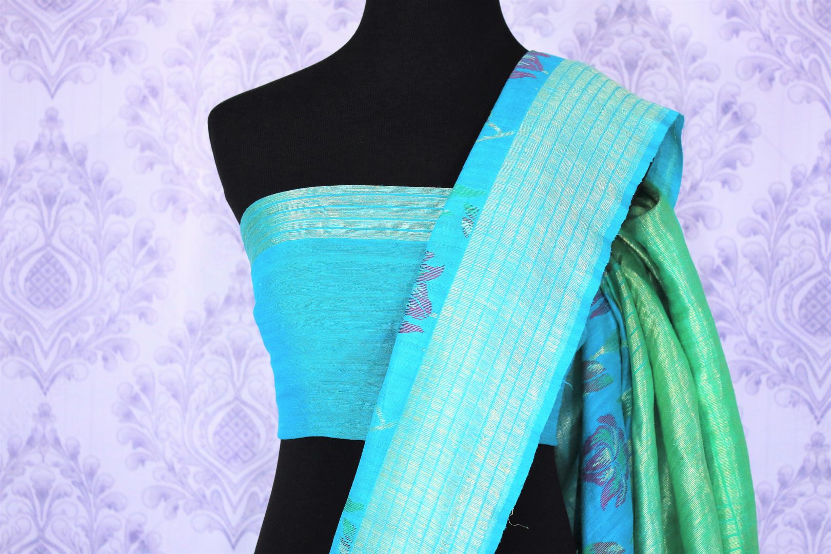 Emanate suave vibes as you drape this green floral embroidered muga banarsi silk saree. It comes with a stunning zari pallu and turquoise shaded blouse. The striking blend of colors is flawless. Shop designer silk sarees, ikkat sarees , banarsi saris online or visit Pure Elegance store in USA.-blouse pallu