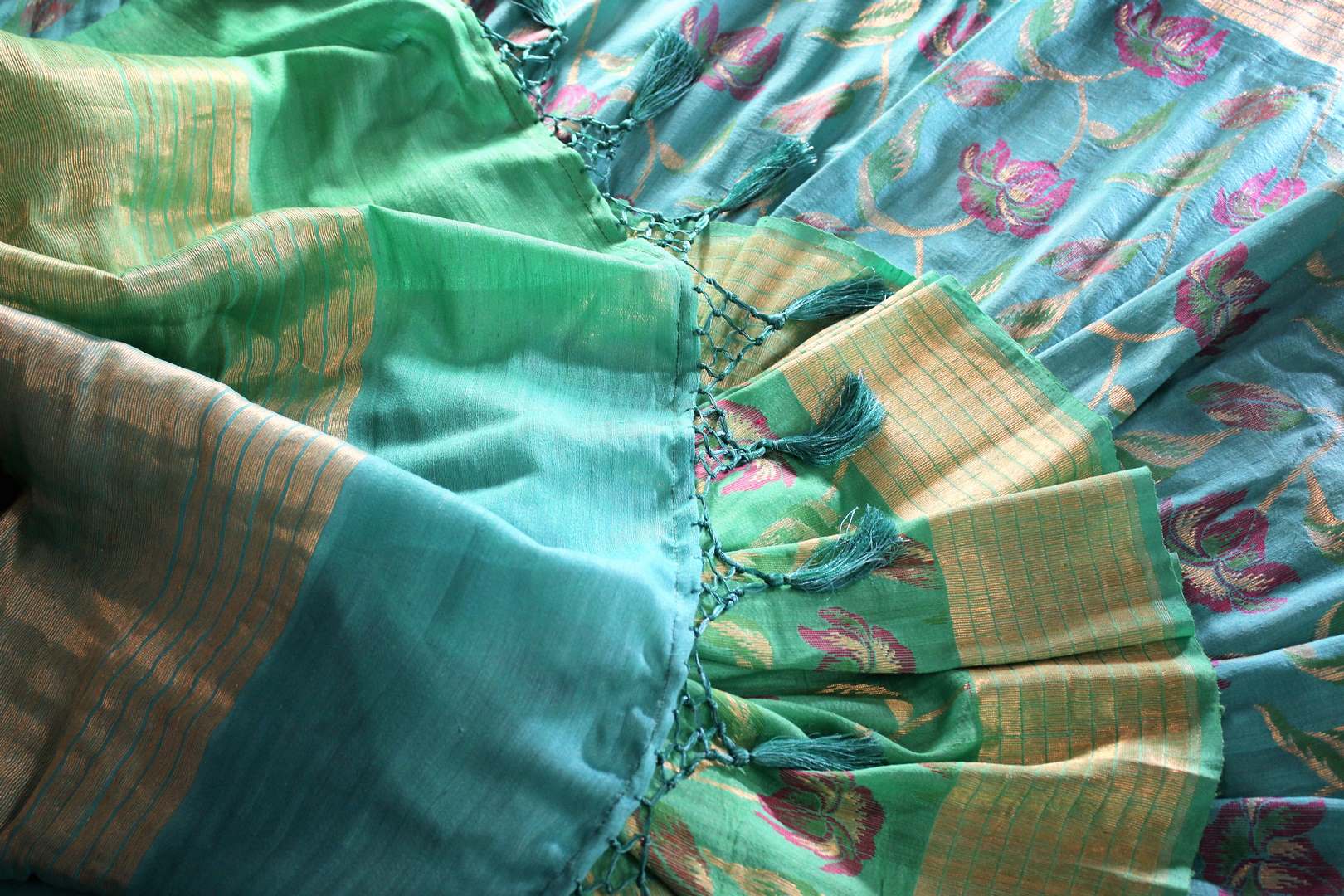 Emanate suave vibes as you drape this green floral embroidered muga banarsi silk saree. It comes with a stunning zari pallu and turquoise shaded blouse. The striking blend of colors is flawless. Shop designer silk sarees, ikkat sarees , banarsi saris online or visit Pure Elegance store in USA.-details