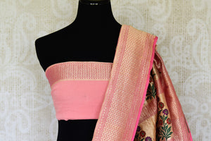 Exude feminity in this pink georgette banarsi silk saree. Perfect for summer-time weddings and parties, this sari comes with a stylish pink blouse. The sari has a zari border and handwoven motifs all over with a rich embroidered pallu. Shop such handcrafted silk sarees online or visit Pure Elegance store, USA. -blouse pallu