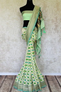 Add oodles of poise to your look with our green georgette banarsi silk saree. It comes with a graceful zari border and handwoven motifs all over. Style it with a soft green zari embroidered blouse to up your style game. Shop such designer silk sari online or visit Pure Elegance store, USA.-full view