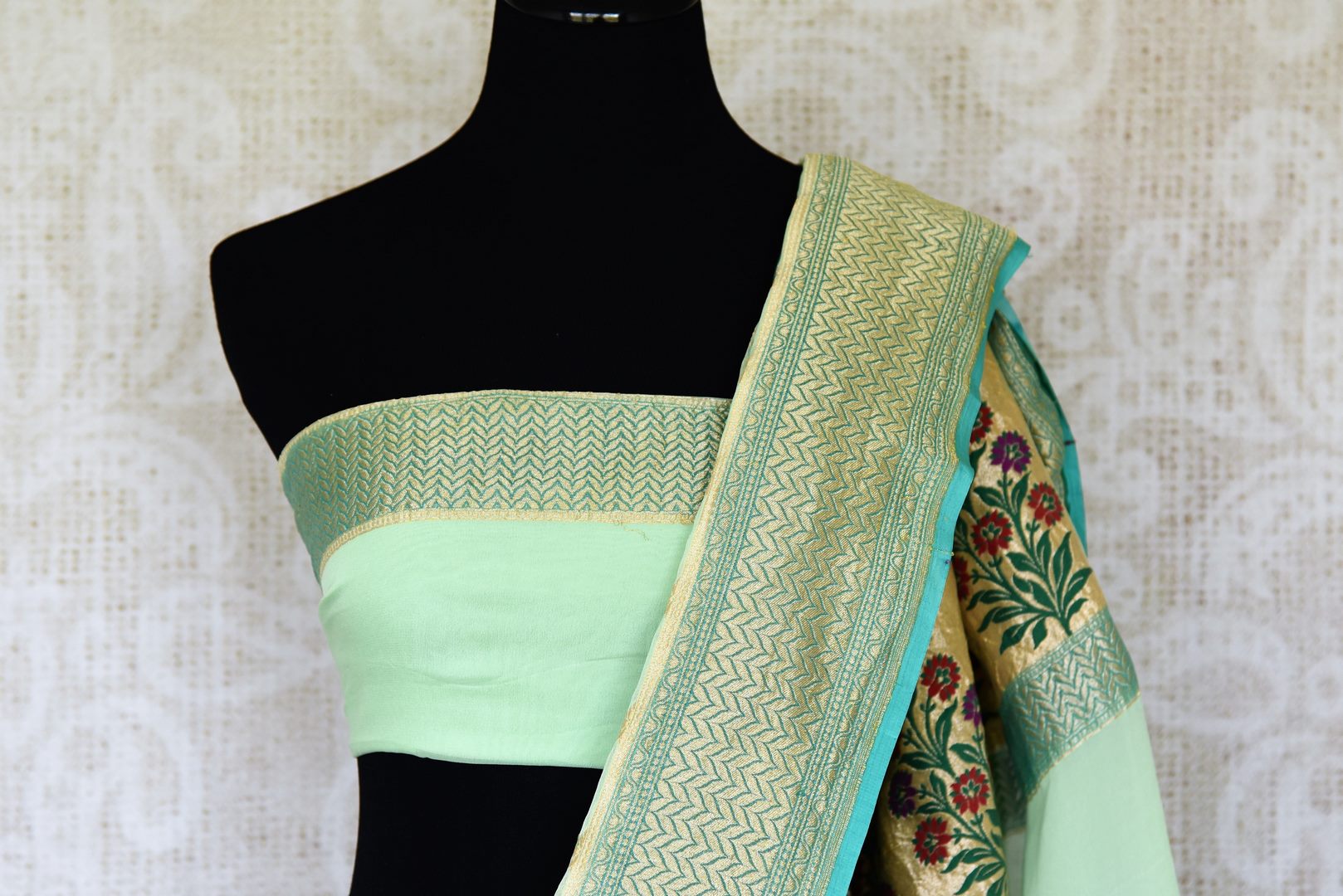Add oodles of poise to your look with our green georgette banarsi silk saree. It comes with a graceful zari border and handwoven motifs all over. Style it with a soft green zari embroidered blouse to up your style game. Shop such designer silk sari online or visit Pure Elegance store, USA.-blouse pallu