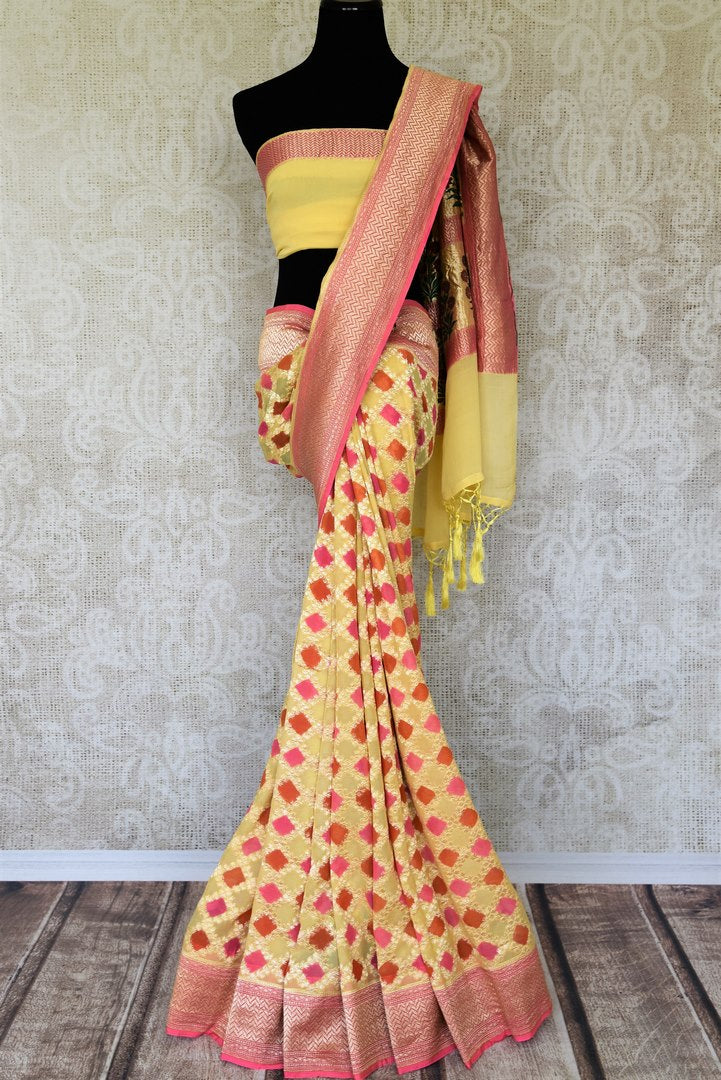 Look alluring in this gorgeous yellow georgette banarsi silk saree. It comes with a royal zari border and handwoven motifs all over the sari. Style it with a yellow zari detailed blouse. Shop printed sarees, embroidery sari online or visit Pure Elegance store, USA.-full view