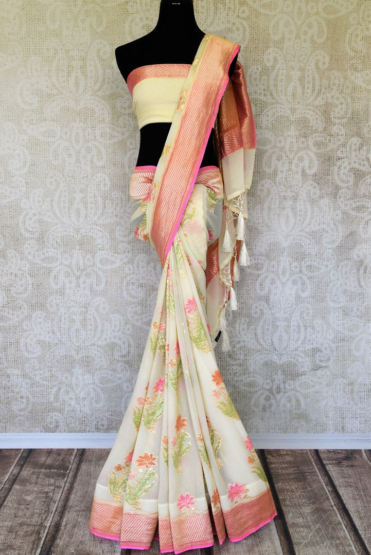 Strike a lasting impression in our white georgette banarasi silk saree. It has a gorgeous zari border accompanied with an equally stunning white zari blouse. Style it for social events, soirees and family gatherings. Shop such designer printed sari, embroidery saree online or visit Pure Elegance store, USA.-full view
