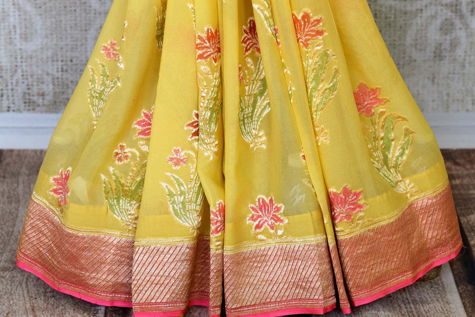Flaunt your summertime style in this peppy yellow georgette banarsi silk saree with a zari border. Style it with a stunning yellow zari blouse. The gorgeous detailing is drool-worthy and you can shop such designer silk saris, linen sarees, ikkat saris online or visit Pure Elegance store, USA.-pleats