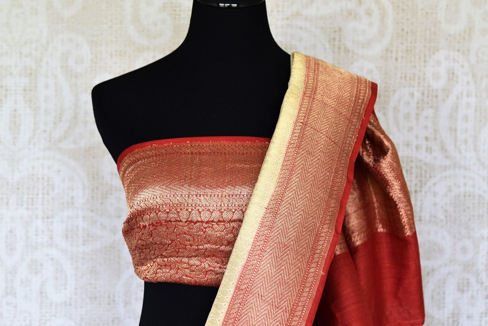 Treat yourself with this suave white khaddi banarsi silk saree paired with a stunning designer red blouse. Featuring zari work on the saree, and intricate buta work, it looks spectacular. Shop such designer silk sarees, printed sari, embroidery saree online or visit Pure Elegance store, USA.-blouse pallu