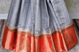 Buy graceful grey tussar Banarasi saree online in USA with red zari border and buta. Make an elegant ethnic fashion statement at parties, weddings and special occasions with a splendid collection of Indian designer sarees, Banarasi saris, handwoven saris from Pure Elegance Indian clothing store in USA or shop online.-pleats
