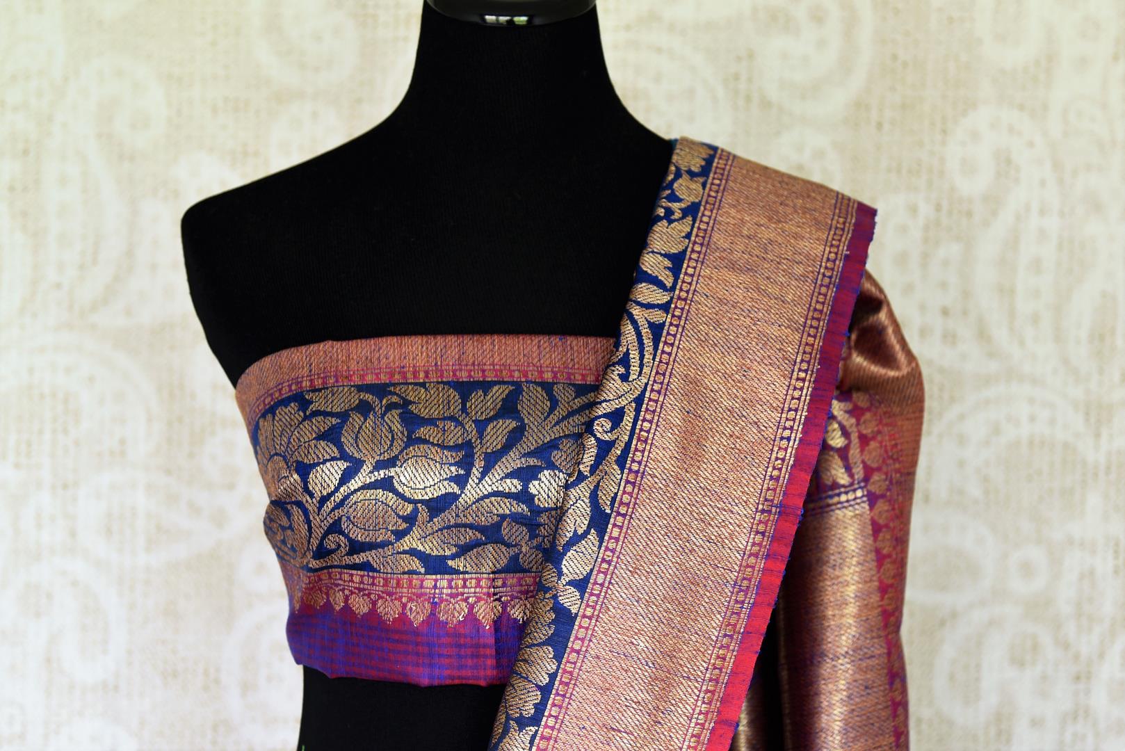 Indulge in the ethereal beauty of this royal blue tussar banarsi silk saree which comes with buta work and zari border. Style it with a designer blouse and steal the limelight as you sashay in a heavily embroidered pallu. Shop handloom sarees, georgette sari, ikkat saree online or visit Pure Elegance store, USA. -blouse pallu