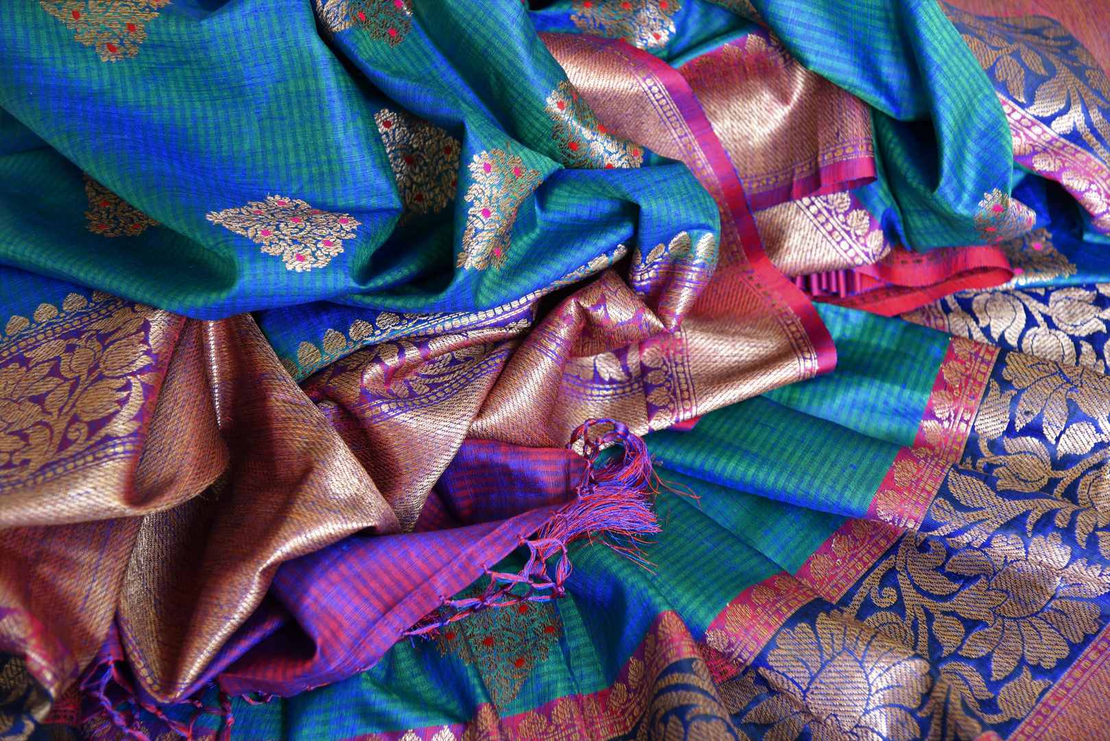 Indulge in the ethereal beauty of this royal blue tussar banarsi silk saree which comes with buta work and zari border. Style it with a designer blouse and steal the limelight as you sashay in a heavily embroidered pallu. Shop handloom sarees, georgette sari, ikkat saree online or visit Pure Elegance store, USA. -details