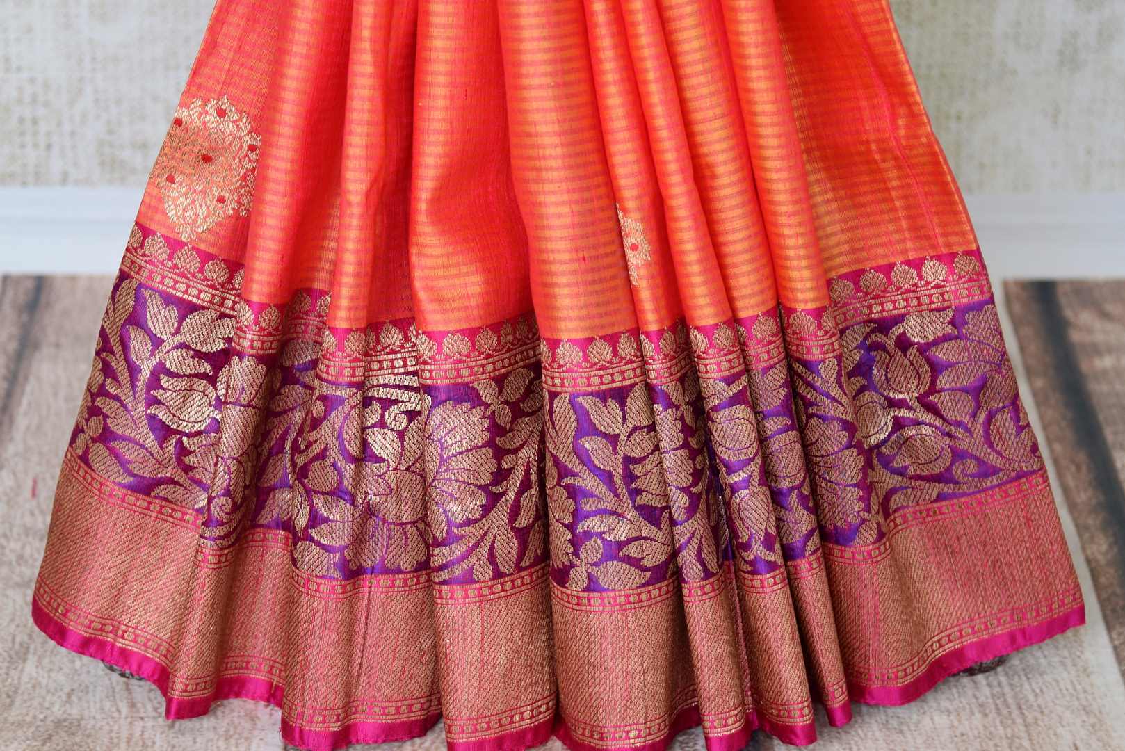 Drape the authenticity of this orange tussar silk banarsi saree with intricate buta work. The zari work on the border and heavily woven pallu enhances the beauty. Style this saree with a designer blouse in contrasting weaves. Shop handcrafted banarsi silk sari, linen saree, online or visit Pure Elegance store, USA. -pleats