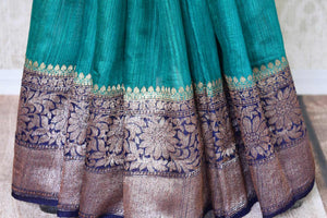 Accentuate your beauty with this exclusively designed mint green matka banarsi silk saree. It comes with a gorgeous zari handwoven border and a contrasting royal blue zari blouse. Complement the sari with pearl jewelry. Shop designer banarsi silk sari, organza saree, linen sari online or visit Pure Elegance store, USA.-pleats