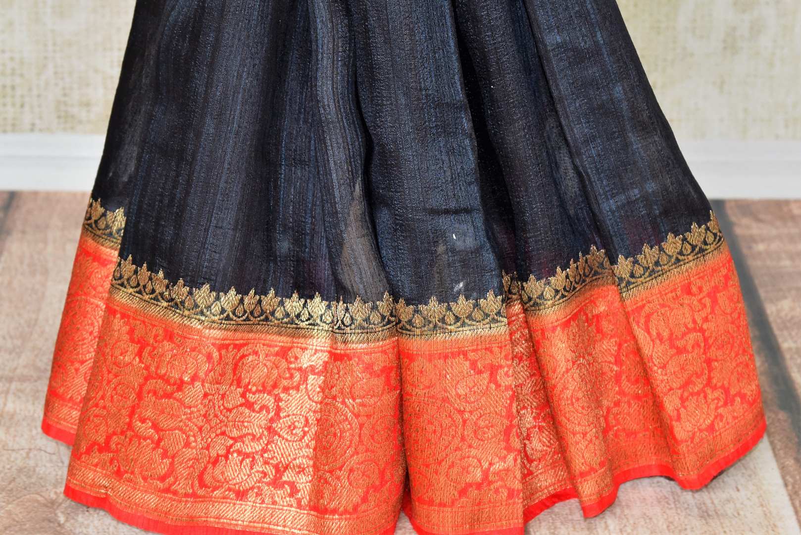 Enhance the subtle charm with classic black matka banarsi silk saree which comes with a vibrant red zari border. Strut to social events in this ensemble. Style it with a gorgeous red zari blouse to turn heads. Shop handloom sarees, kanjeevaram silk sari, linen sari online or visit Pure Elegance store, USA. -pleats