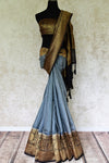 Channel sophistication in grey matka banarsi silk saree. A perfect pick for festivities and formal events, style this saree with a contrasting black and gold zari woven blouse. The gold zari border flows throughout the sari. Shop banarsi silk sarees, linen sari, georgette saree online or visit Pure Elegance store, USA.-full view