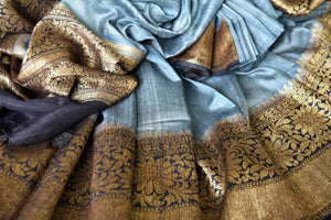 Channel sophistication in grey matka banarsi silk saree. A perfect pick for festivities and formal events, style this saree with a contrasting black and gold zari woven blouse. The gold zari border flows throughout the sari. Shop banarsi silk sarees, linen sari, georgette saree online or visit Pure Elegance store, USA.-details
