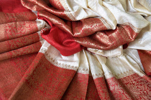 Fall in love with all things classic like this cream matka banarsi silk saree. The sensational combination of cream and red makes it even alluring. The red zari border and contrasting red blouse enhance the beauty. Shop designer silk saree, ikkat sari, georgette saree online or visit Pure Elegance store, USA.-details