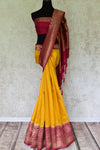Shine bright like a sunshine in our vibrant yellow matka banarsi silk sari which is blended well with a pink zari border. Style this effervescent saree with a hot pink zari blouse to catch the fancy of folks around. Shop designer silk sarees, georgette sari, organza sari online or visit Pure Elegance store, USA.-full view