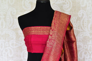 Shine bright like a sunshine in our vibrant yellow matka banarsi silk sari which is blended well with a pink zari border. Style this effervescent saree with a hot pink zari blouse to catch the fancy of folks around. Shop designer silk sarees, georgette sari, organza sari online or visit Pure Elegance store, USA.-blouse pallu
