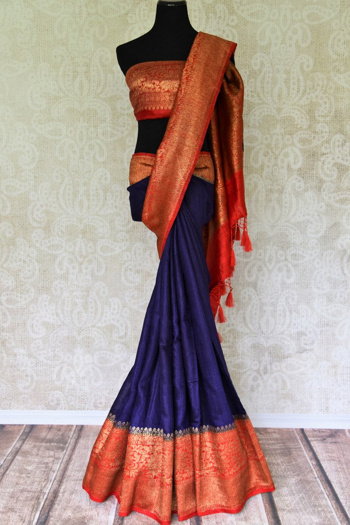 Up your stylish appeal in this royal blue matka banarsi silk saree with a graceful red zari border. Style this saree with a stunning bright red zari designer blouse complemented with a heavily woven pallu. Shop handloom sarees, linen sari, chiffon saree online or visit Pure Elegance store, USA.-full view
